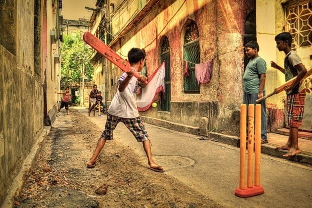 Children playing cricket on the streets