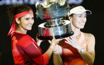 Switzerland's Martina Hingis (R) and India's Sania Mirza pose with the trophy after winning their doubles final match at the Australian Open tennis tournament at Melbourne Park, Australia, January 29, 2016.