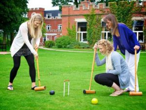 women playing croquet