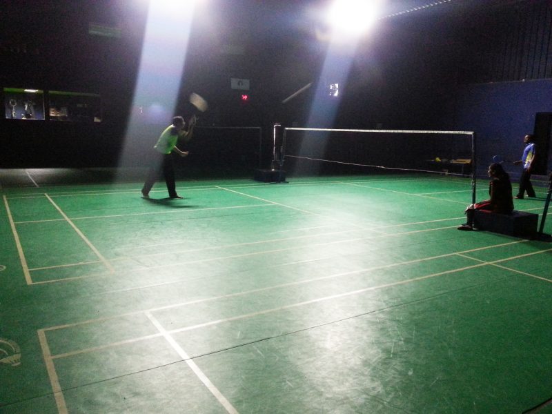 Badminton courts being engaged by players