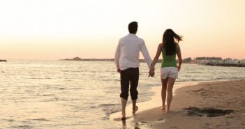 6 Mysterious Benefits Of Talking A Lazy Walk a couple holding hands and walking down the beach
