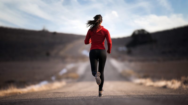 a lady running on the road