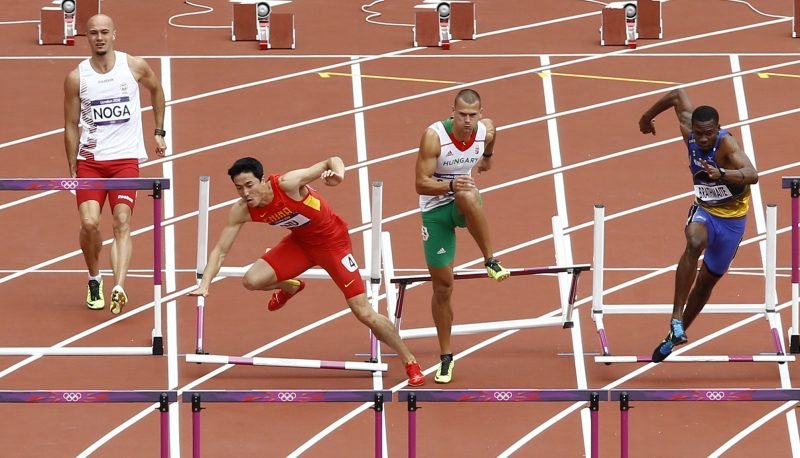 an athlete falling off the hurdles