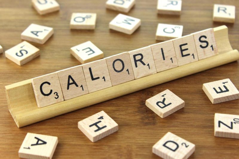 A scrabble board showing the word calories.