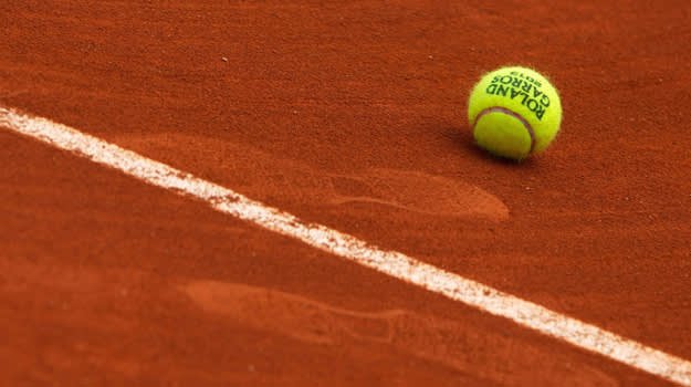 A ball lying on a clay court